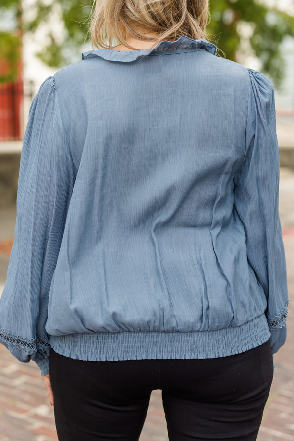 Chic Soul plus size clothing, denim blue long sleeve flowy top with v neckline and cuff sleeves with ruffle detail along neckline and front with eyelet details on front and sleeves