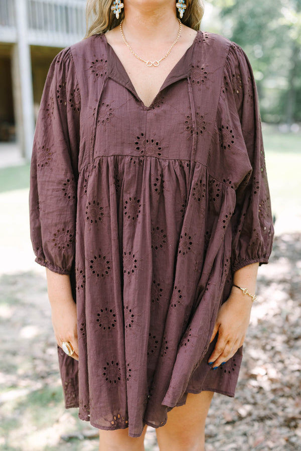 Plus Size brown cotton eyelet dress with a V-neckline, tie details, and long puff sleeves.