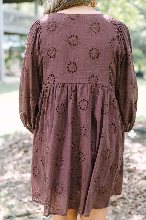 Plus Size brown cotton eyelet dress with a V-neckline, tie details, and long puff sleeves.