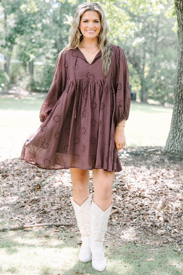 Plus Size brown cotton eyelet dress with a V-neckline, tie details, and long puff sleeves.