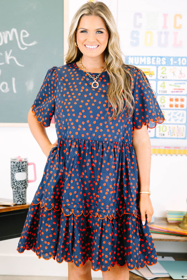 Plus Size navy dress with red apple print, tiered skirt, and scalloped red piping on sleeves.
