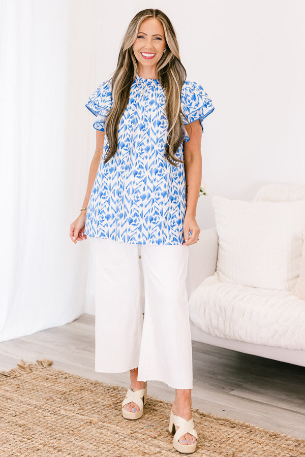 Plus Size blue and white abstract print top with flutter sleeves and a high neckline.