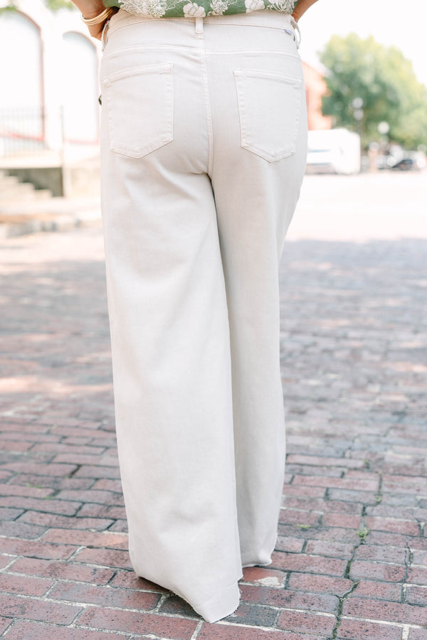 Plus Size almond-colored wide-leg jeans with a high-waist fit and raw-edge hem.