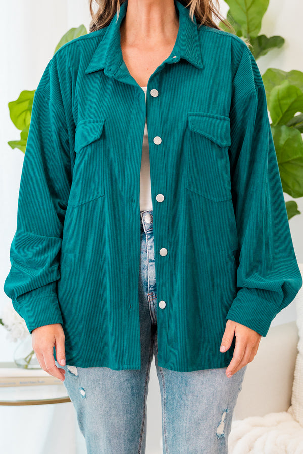 Plus Size teal corduroy button-down jacket with chest pockets over a white top and light wash jeans.