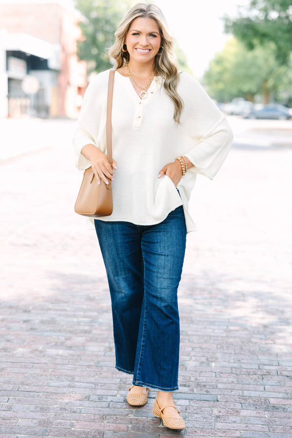Plus Size cream knitted henley top with a relaxed fit, long sleeves, and button-down neckline.