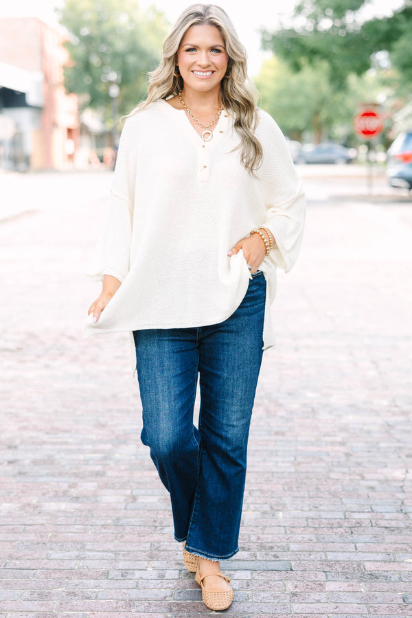 Plus Size cream knitted henley top with a relaxed fit, long sleeves, and button-down neckline.