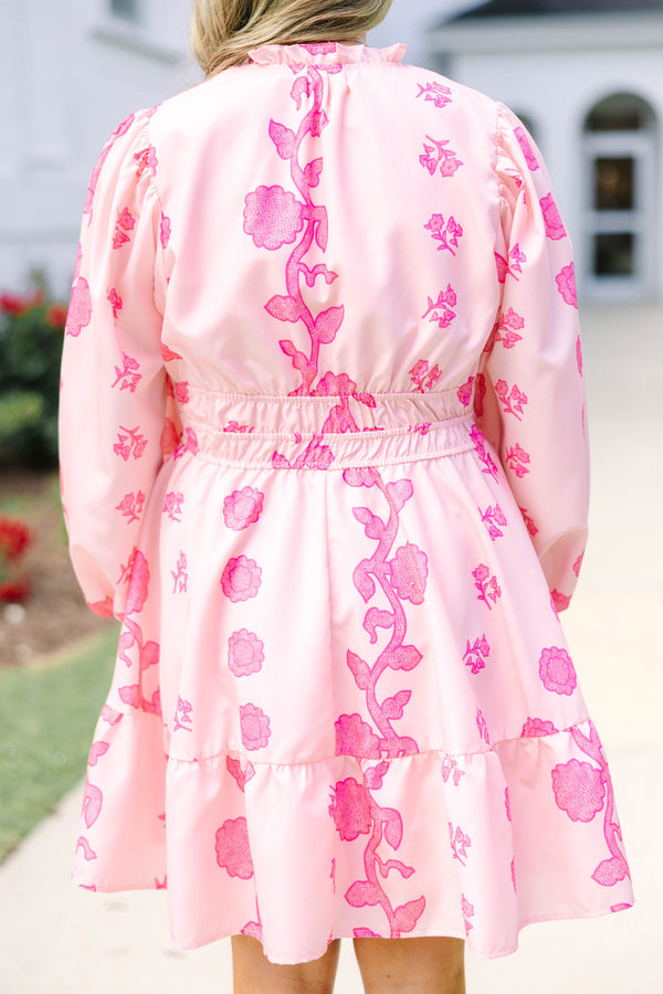 Plus Size pink floral mini dress with long puff sleeves, a smocked waist, and a ruffled hem.