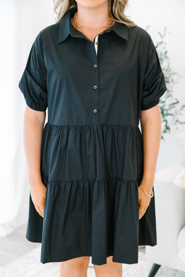 Plus size black cotton tiered shirt dress with short puff sleeves and a flowy, relaxed fit.