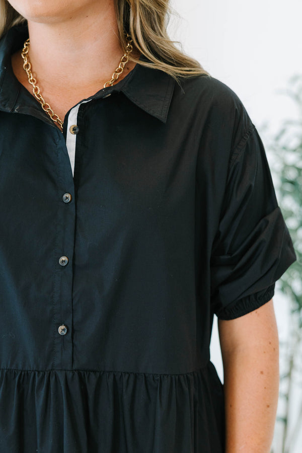 Plus size black cotton tiered shirt dress with short puff sleeves and a flowy, relaxed fit.