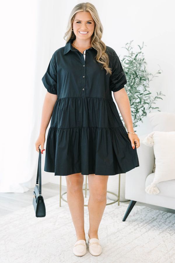 Plus size black cotton tiered shirt dress with short puff sleeves and a flowy, relaxed fit.