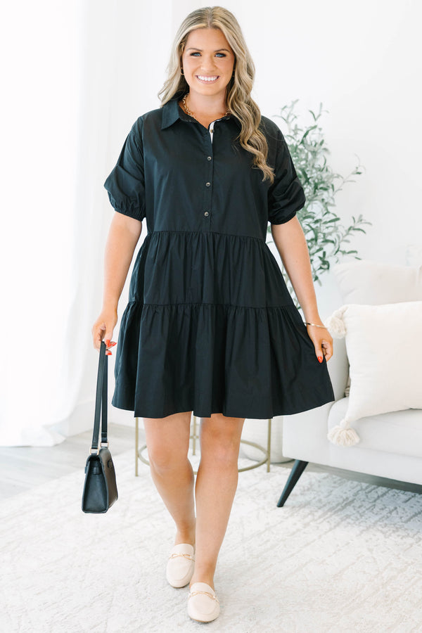 Plus size black cotton tiered shirt dress with short puff sleeves and a flowy, relaxed fit.