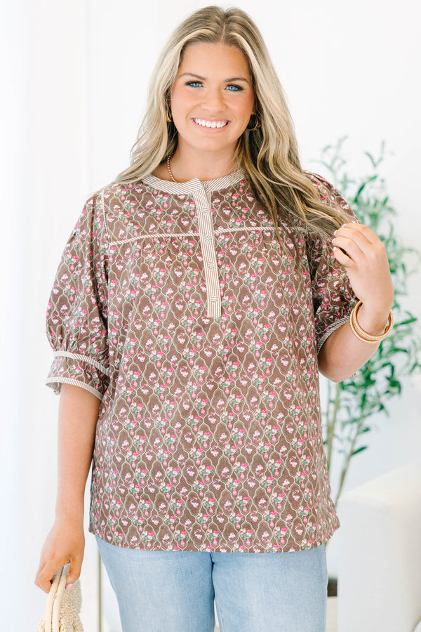 Plus Size brown floral top with puff sleeves, a striped henley neckline, and light wash jeans.