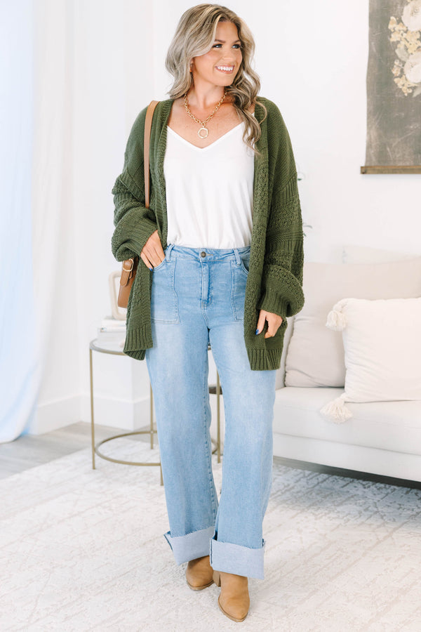 Plus size light wash high-rise wide-leg jeans featuring oversized cuffed hems and patch pockets.