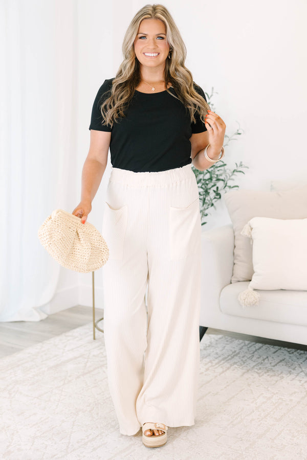Plus size cream ribbed wide-leg pants with an elastic waist and front pockets for a flowy fit.