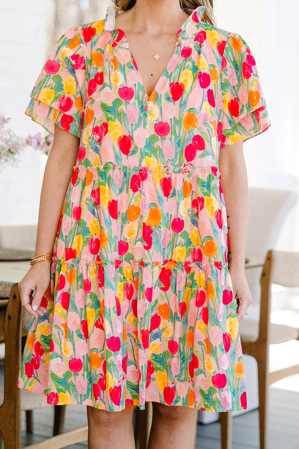 Plus Size pink v-neck dress with a colorful tulip print and layered flutter sleeves.