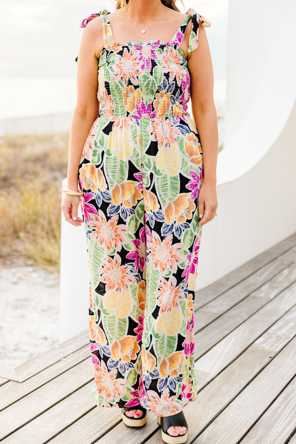 Chic Soul plus size clothing, black sleeveless flowy jumpsuit with a smocked bodice and tied straps with a multi-colored floral pattern