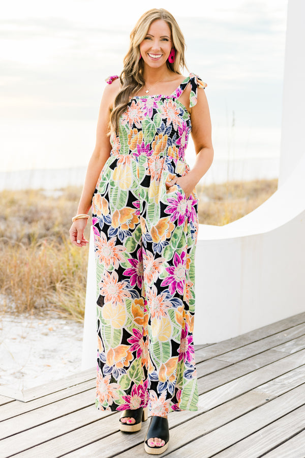 Chic Soul plus size clothing, black sleeveless flowy jumpsuit with a smocked bodice and tied straps with a multi-colored floral pattern