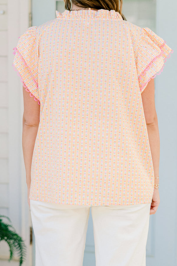 Plus Size pink ditsy floral top with flutter sleeves, tassel ties, and functional buttons.