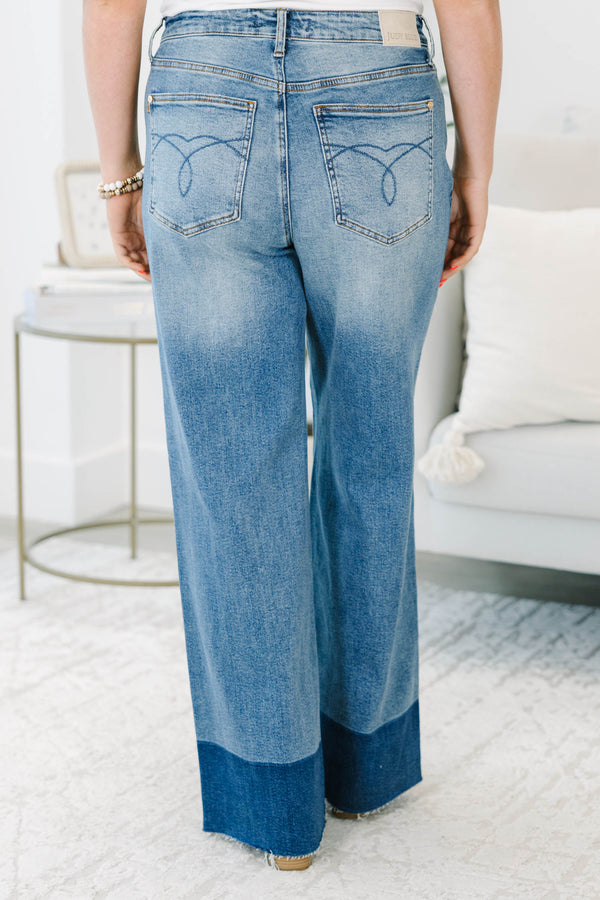 Plus Size high-waisted wide leg jeans in a medium wash with a dark wash blocked raw hem.