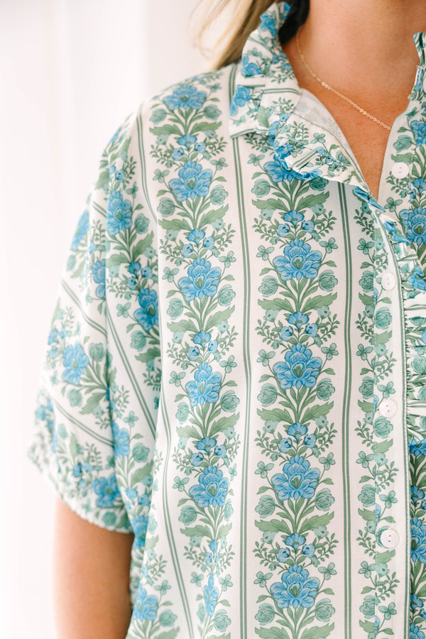 Blue floral stripe top with a ruffle collar, button-front ruffle trim, and  bubble sleeves.