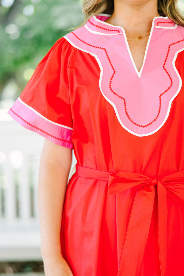 Plus Size red cotton midi dress with pink contrast trim, V-neckline, and adjustable waist belt.