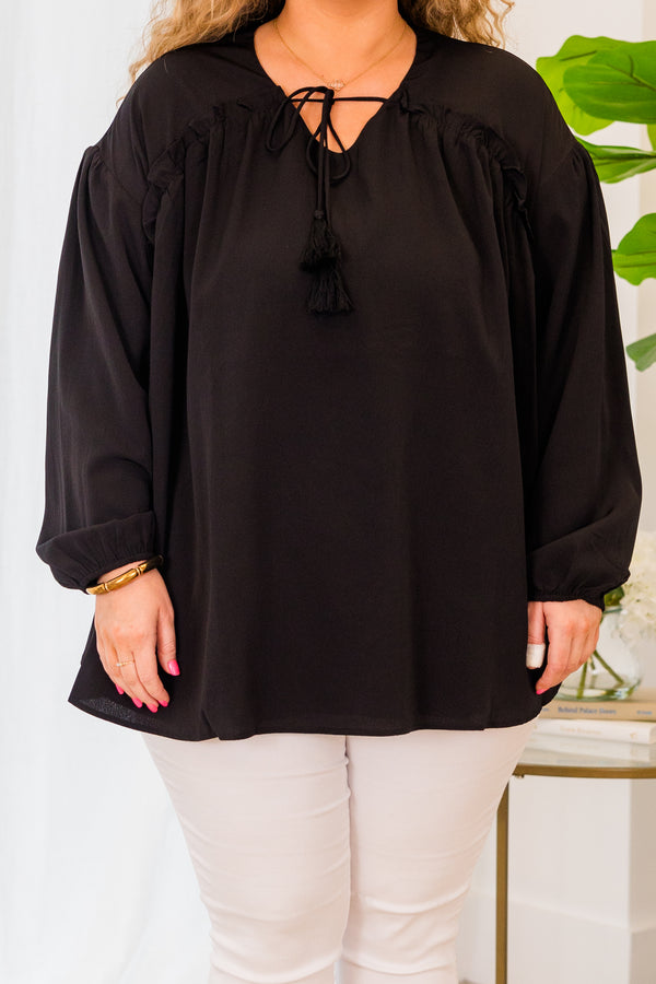 Plus Size black flowy top with long sleeves, a V-neckline, and a tassel tie detail.