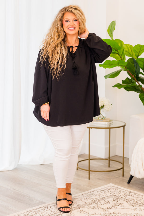 Plus Size black flowy top with long sleeves, a V-neckline, and a tassel tie detail.