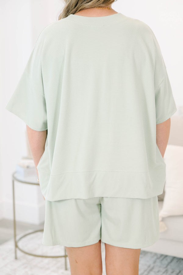 Plus Size sage green two-piece set with a short-sleeve ribbed top and matching pull-on shorts.