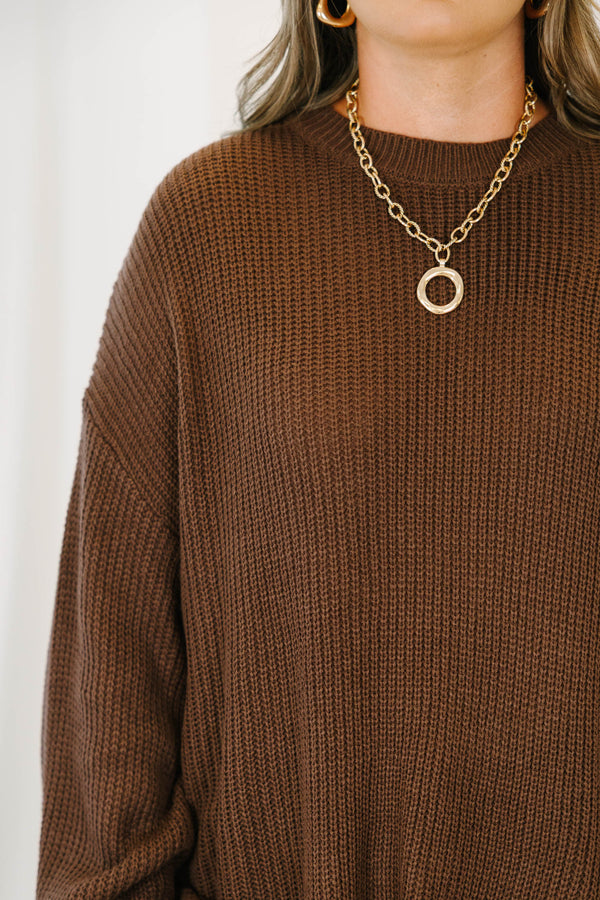Plus size brown, oversized knit sweater with a crew neck and relaxed, flowy fit.