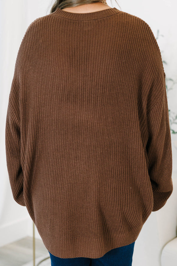 Plus size brown, oversized knit sweater with a crew neck and relaxed, flowy fit.