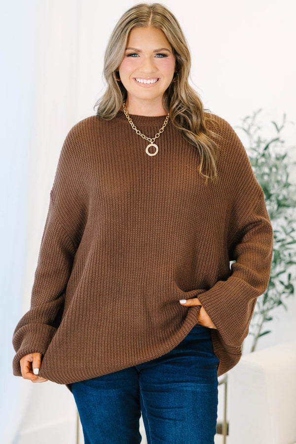 Plus size brown, oversized knit sweater with a crew neck and relaxed, flowy fit.
