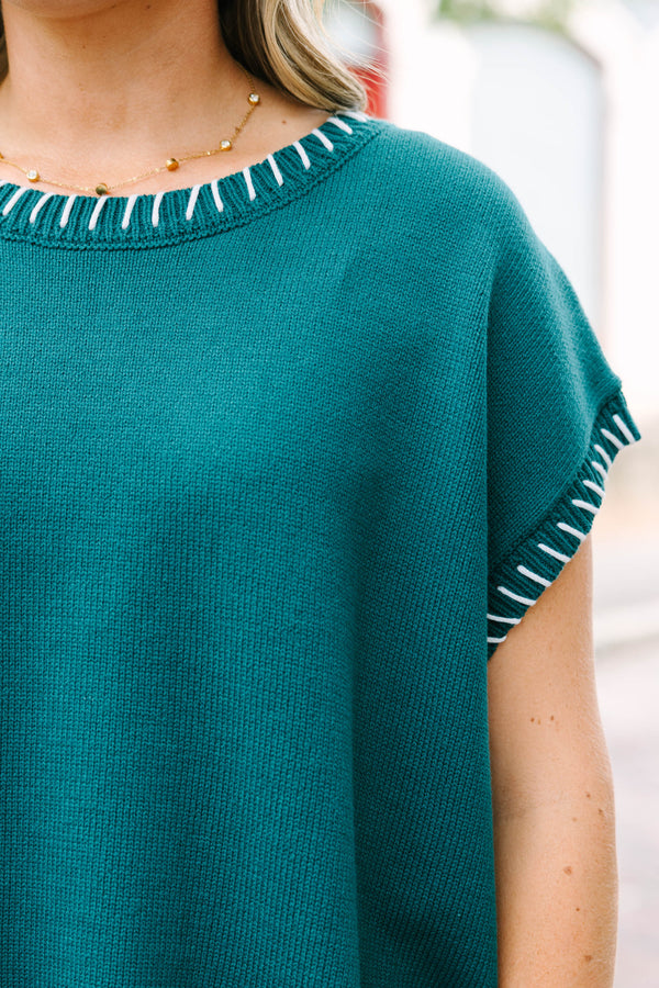 Plus Size hunter green cap sleeve knit top with white blanket stitching on the neckline and arms.