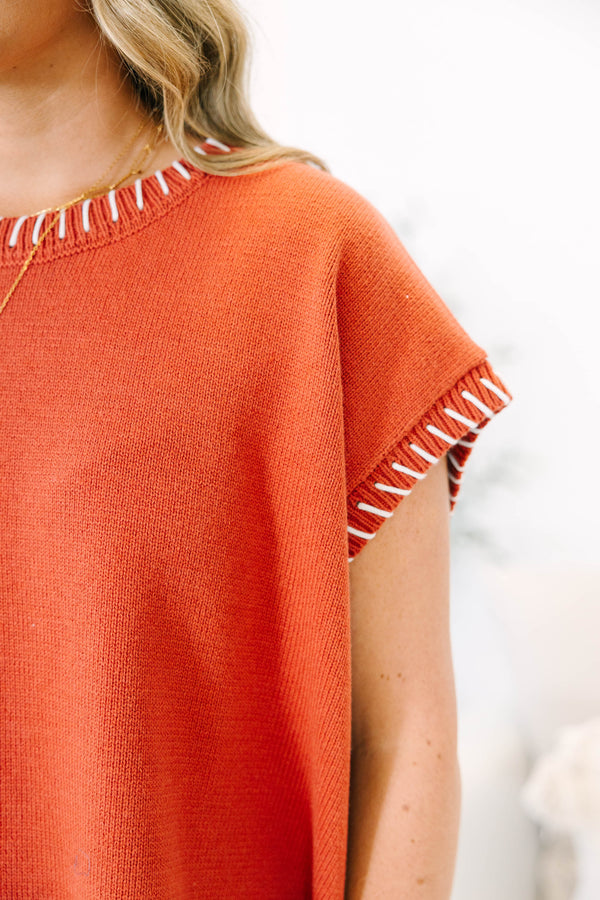 Plus Size rust knit top with white whipstitch trim on the crew neckline and short sleeves.