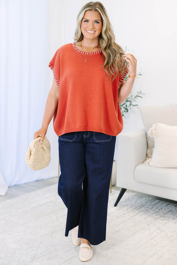 Plus Size rust knit top with white whipstitch trim on the crew neckline and short sleeves.