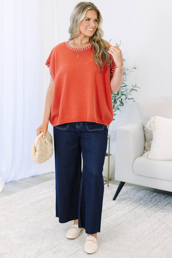 Plus Size rust knit top with white whipstitch trim on the crew neckline and short sleeves.