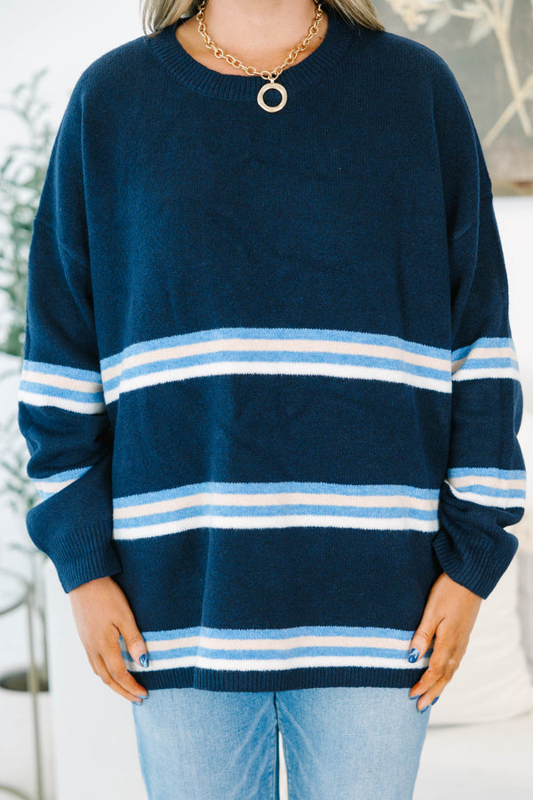 Plus Size navy blue crewneck sweater with horizontal light blue and white stripes and long sleeves.