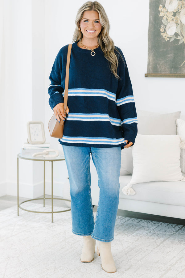 Plus Size navy blue crewneck sweater with horizontal light blue and white stripes and long sleeves.