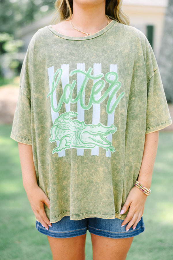 Plus size golden olive acid wash relaxed tee with a green alligator graphic.