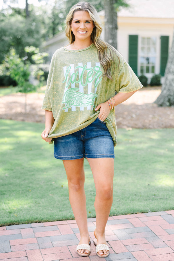 Plus size golden olive acid wash relaxed tee with a green alligator graphic.