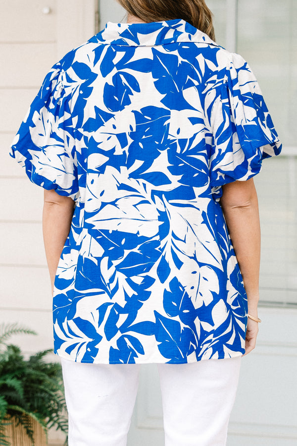 Plus Size off-white and blue leafy print top with a split v-neck and elastic puff sleeves.