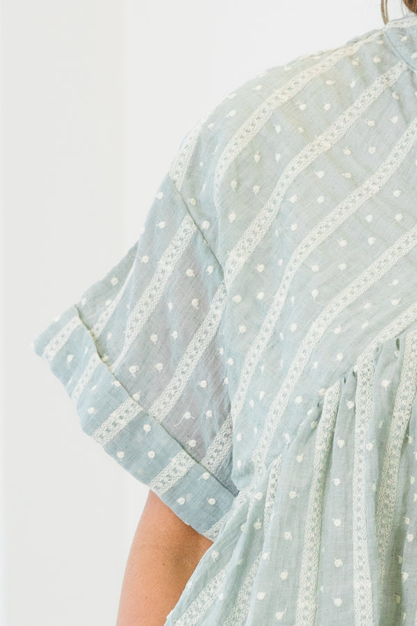 Chic Soul plus size clothing, short-cuffed-sleeve teal green ruffled baby doll top with a split-v-neckline and a high-low hemline with a striped polka dotted abstract pattern 