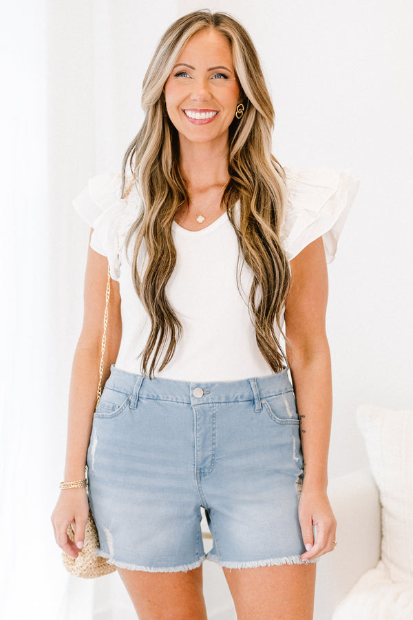 Plus Size light wash high-rise denim shorts with a button fly and cuffed hems.