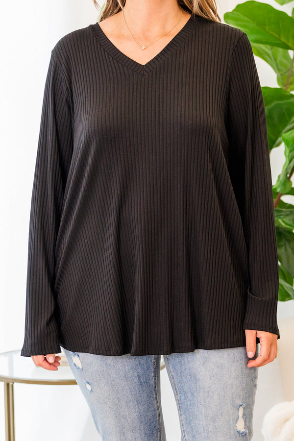 Plus Size black ribbed long sleeve top with a v-neckline and a relaxed fit.