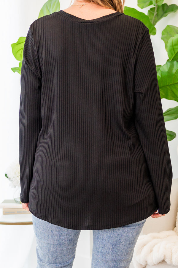 Plus Size black ribbed long sleeve top with a v-neckline and a relaxed fit.