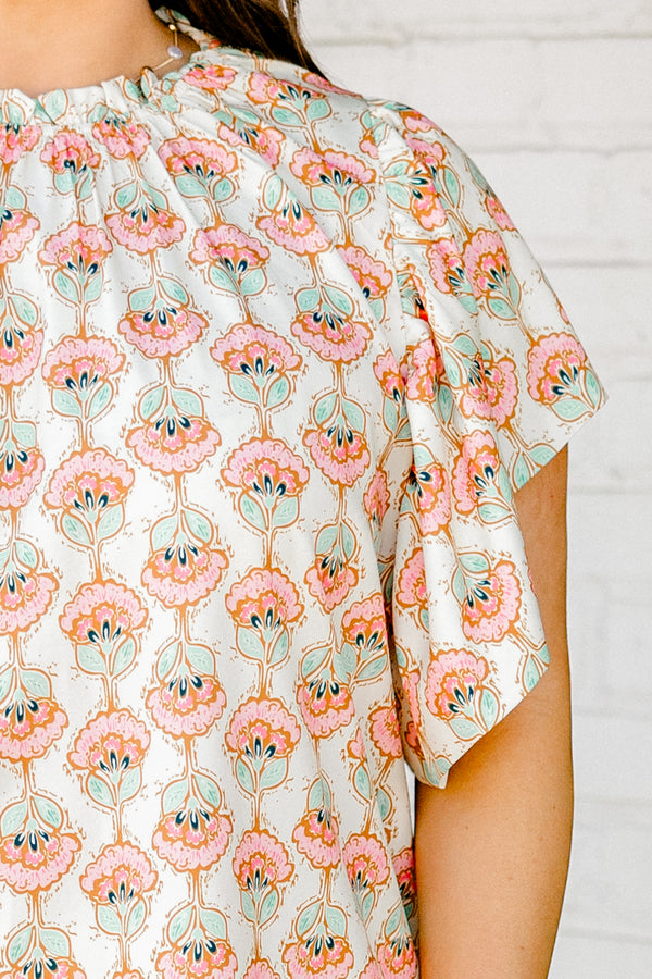 Chic Soul plus size clothing, ivory short sleeve top with light pink/teal paisley design with mock neck with ruffle sleeves
