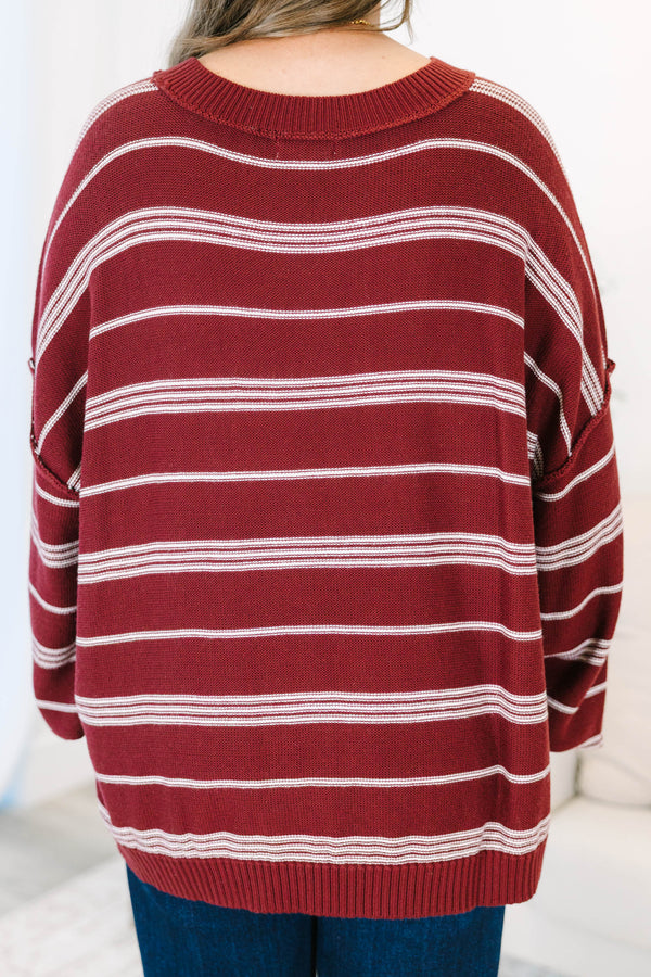 Plus Size burgundy and ivory striped drop shoulder sweater with exposed seams and a crew neckline.
