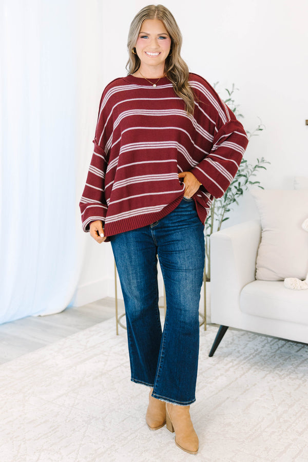 Plus Size burgundy and ivory striped drop shoulder sweater with exposed seams and a crew neckline.