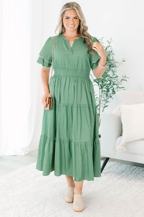 Plus Size olive tiered midi dress with a v-neckline, cinched waist, and scalloped white-piped sleeves.