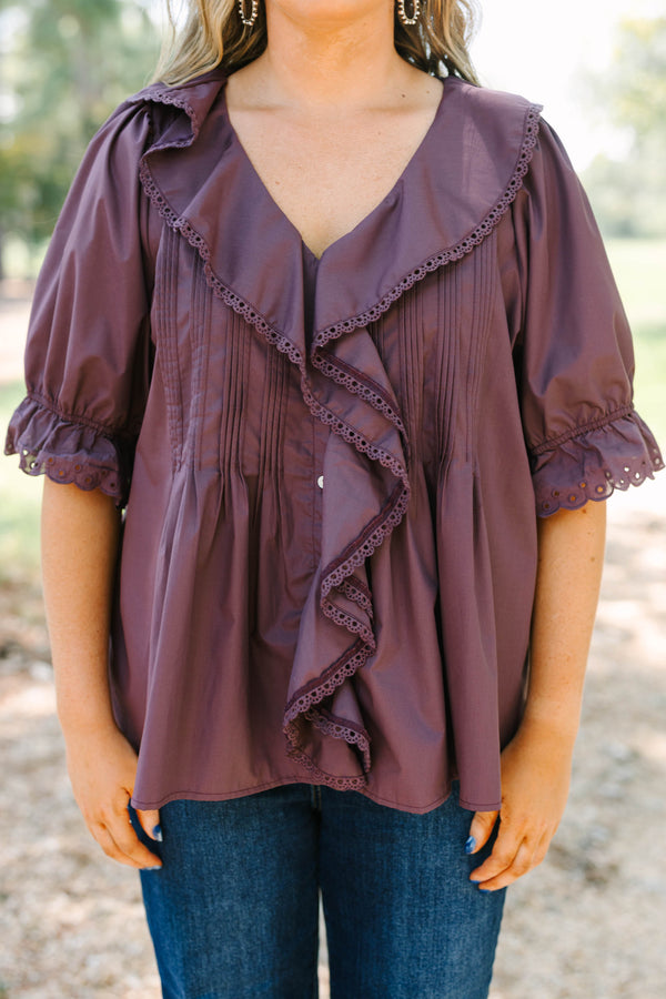 Plus Size brown top with ruffled V-neckline, eyelet trim, button front, and pleated bodice details.