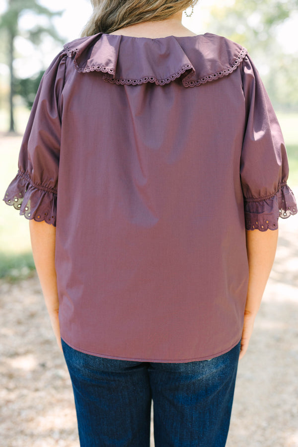 Plus Size brown top with ruffled V-neckline, eyelet trim, button front, and pleated bodice details.